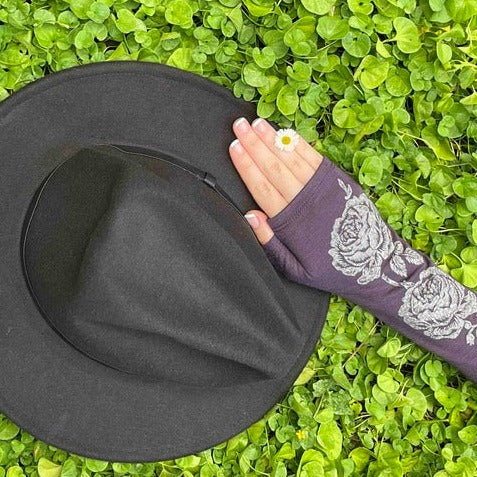 Fingerless merino gloves in purple with silver rose print.