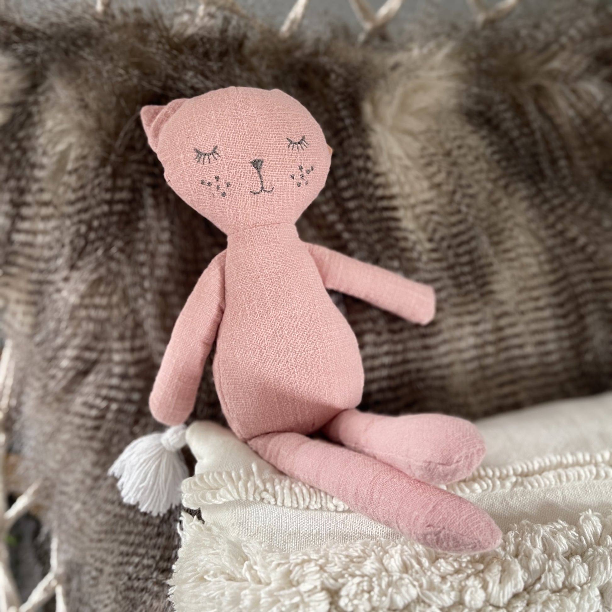 Rose coloured cat toy.
