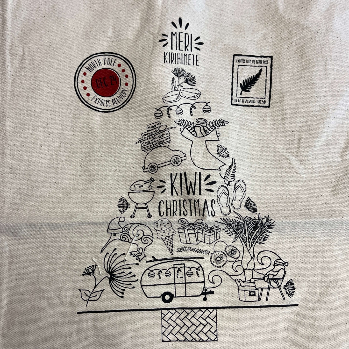 Printing on a Christmas sack featuring a tree made up of Kiwiana icons.