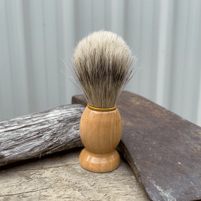 Handmade mens boar bristle shaving brush pictured with an axe.