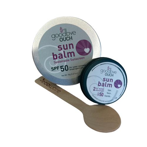 Two tins of sunbalm and a wooden spoon.