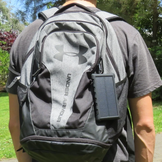 SunSaver 10K, 10,000mAh Solar Power Bank attached to a persons backpack.