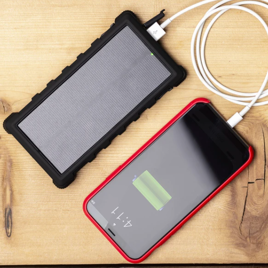 SunSaver 10K, 10,000mAh Solar Power Bank charging a phone and for sale from the school fundraising shop.