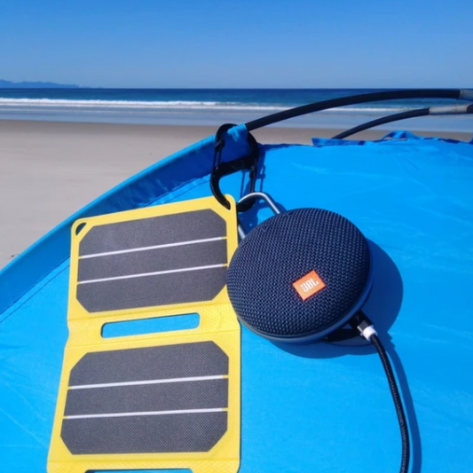 SunSaver Power Flex, 6.4-Watt Solar Charger charging a speaker at the beach camping.