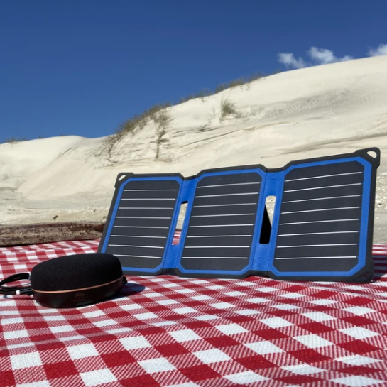 SunSaver Super Flex, 14-Watt Solar Charger on the beach. And charging a speaker.