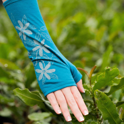 Fingerless merino gloves in teal with white clematis print.