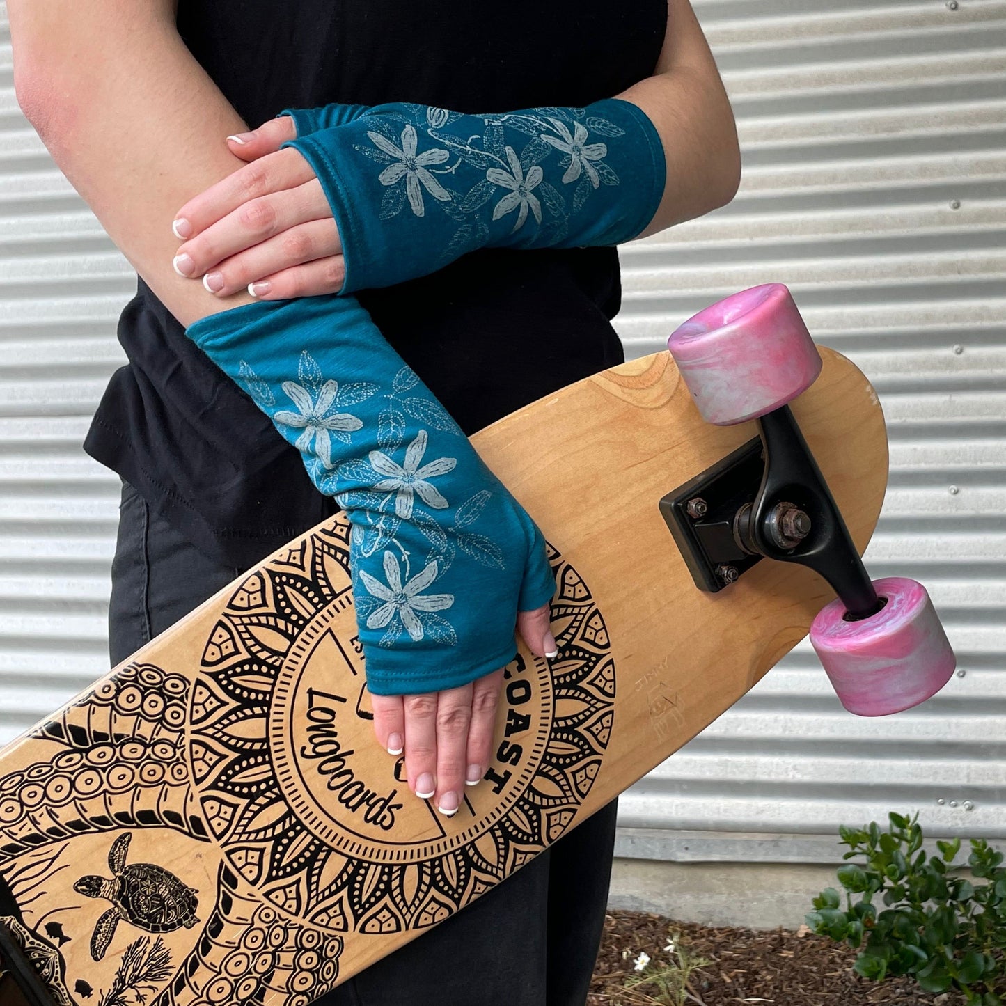 Fingerless merino gloves in teal with white clematis print.