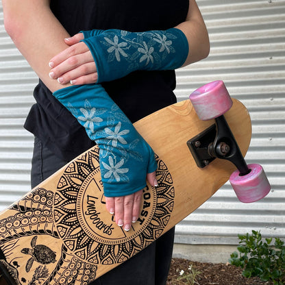 Fingerless merino gloves in teal with white clematis print.