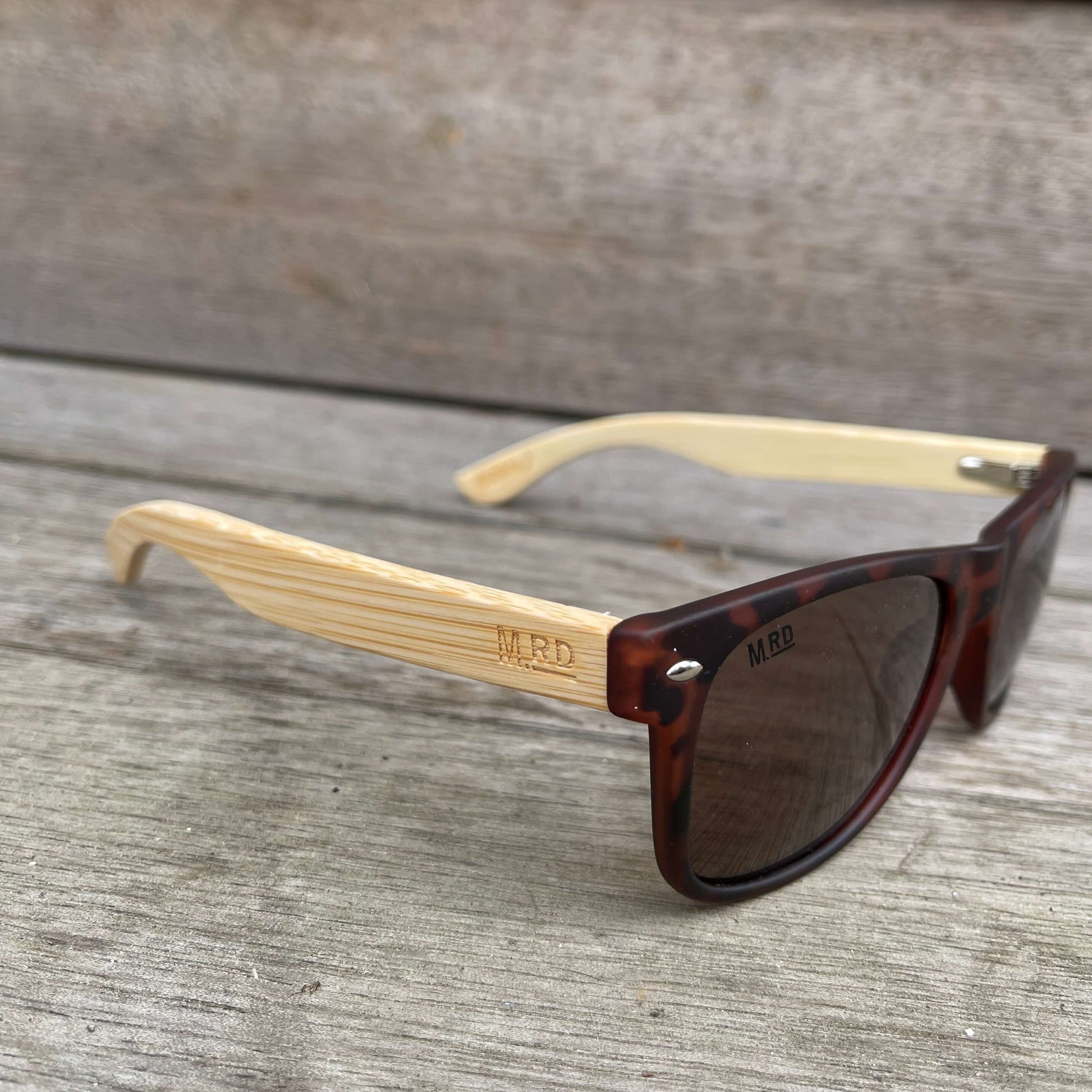 Sunglasses with brown tortoiseshell frames and wooden arms.