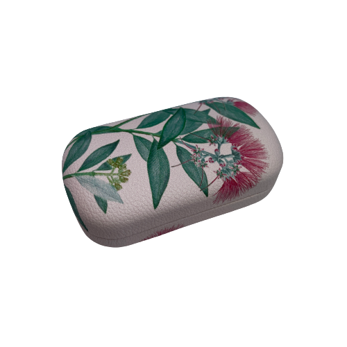 Small trinket case in pale pink with Pohutukawa flowers on it.