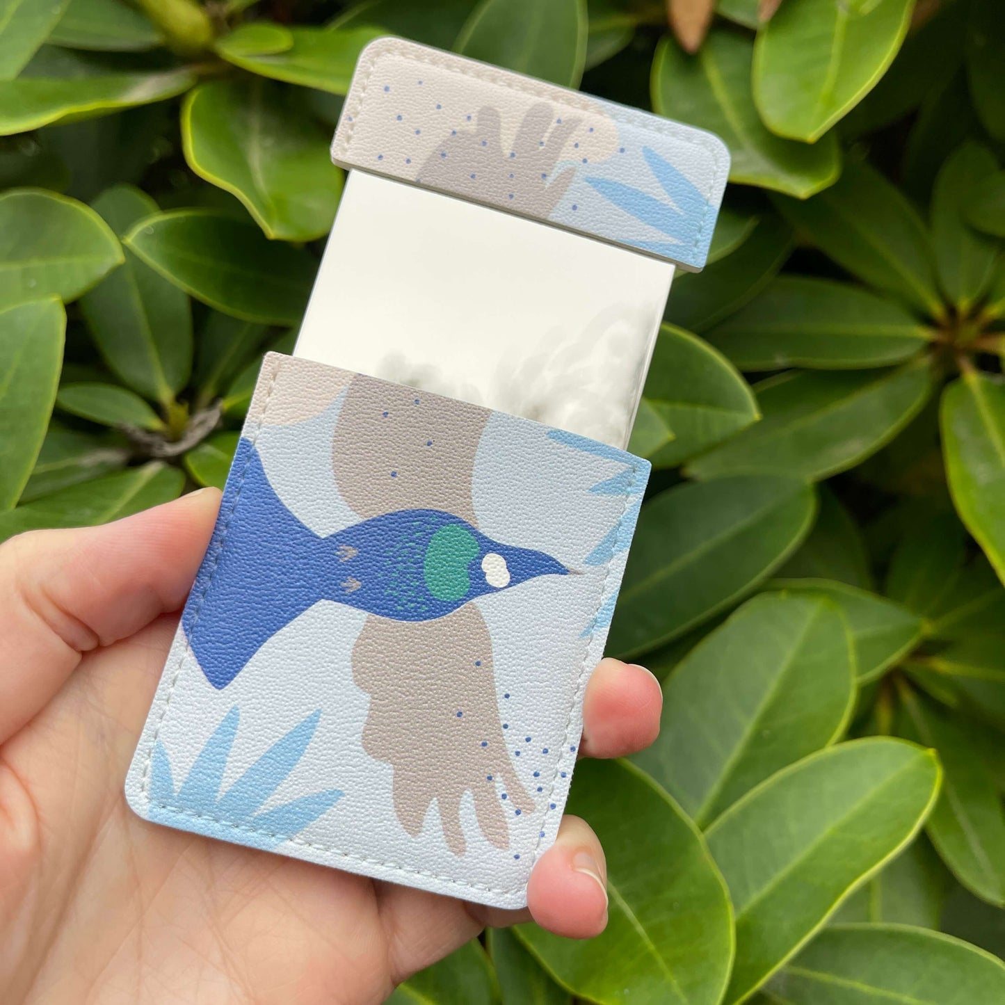 Pocket Mirror - Cut-out Tui with blue and grey accents.