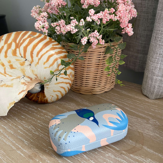 Small trinket case with Tui Bird print in pinks and blues.