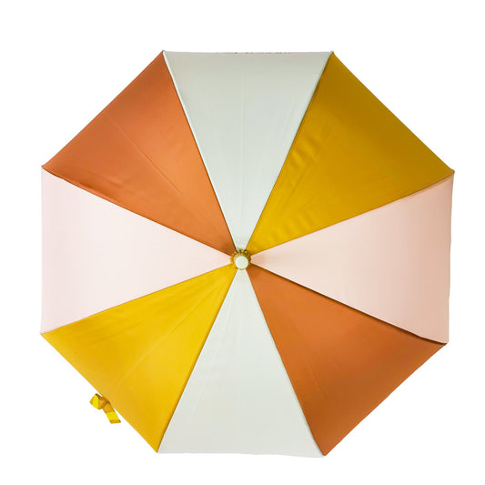 Birds eye view of an open childrens umbrella with coloured panels in mustard, shell and rust.