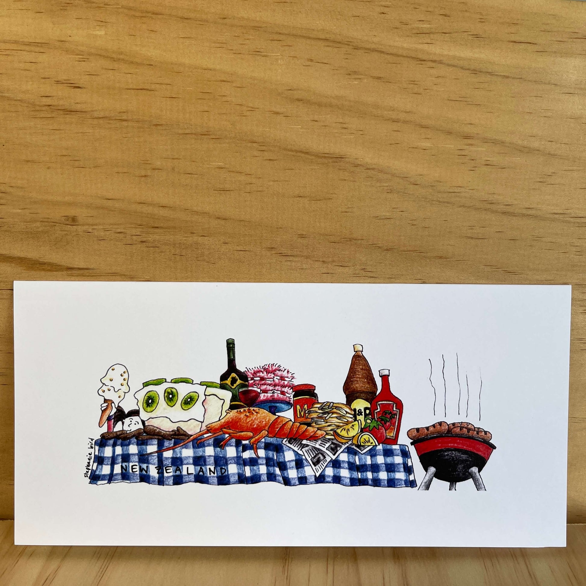 Greeting card with a classic Kiwi BBQ table and food.