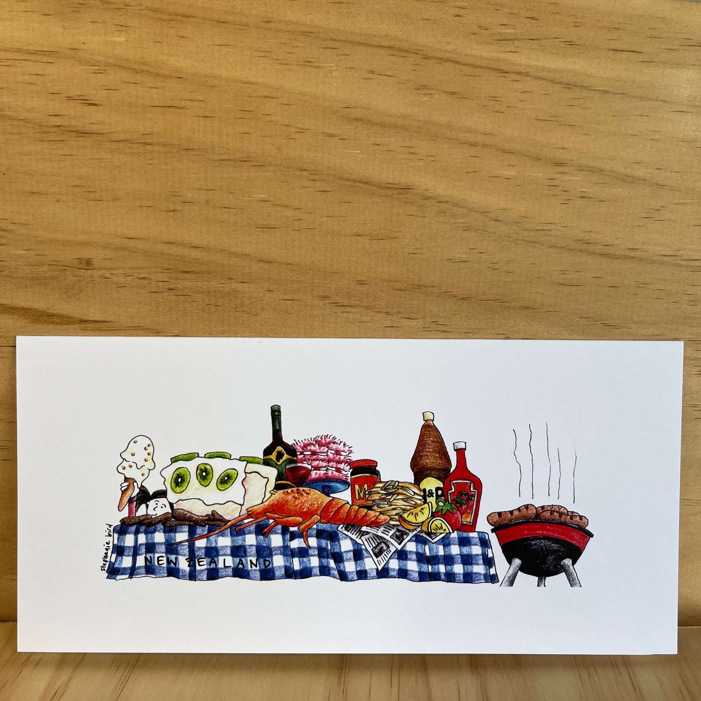 Greeting card with a classic Kiwi BBQ table and food.