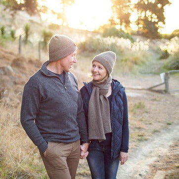 Man & woman walking in the outdoors wearing Wyld woolen knit hats.