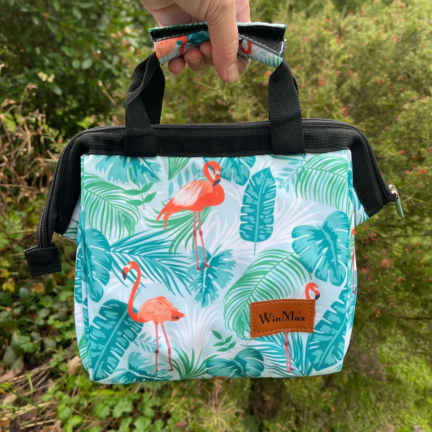 Winmax cooler bag in white with minty green tropical foliage and pink flamingo print.