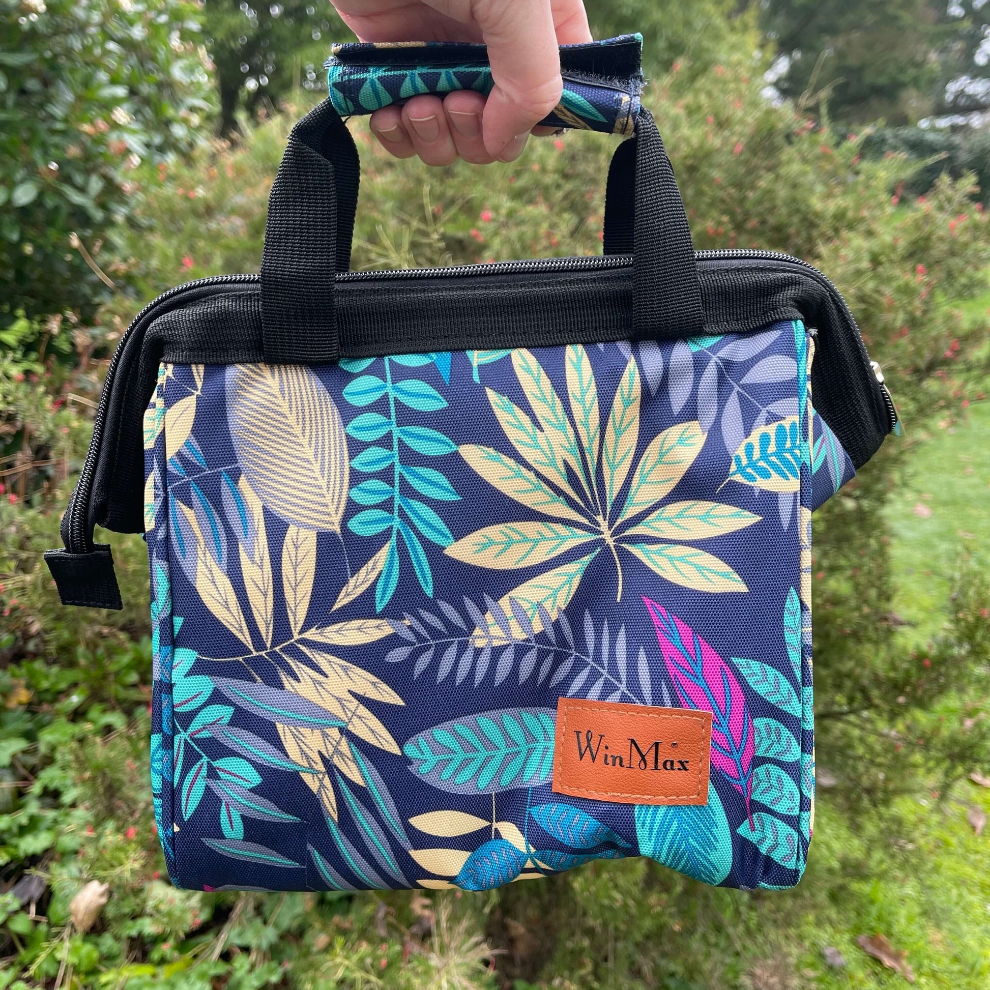 Winmax Cooler bag in navy blue with teal, grey and pink foliage print.