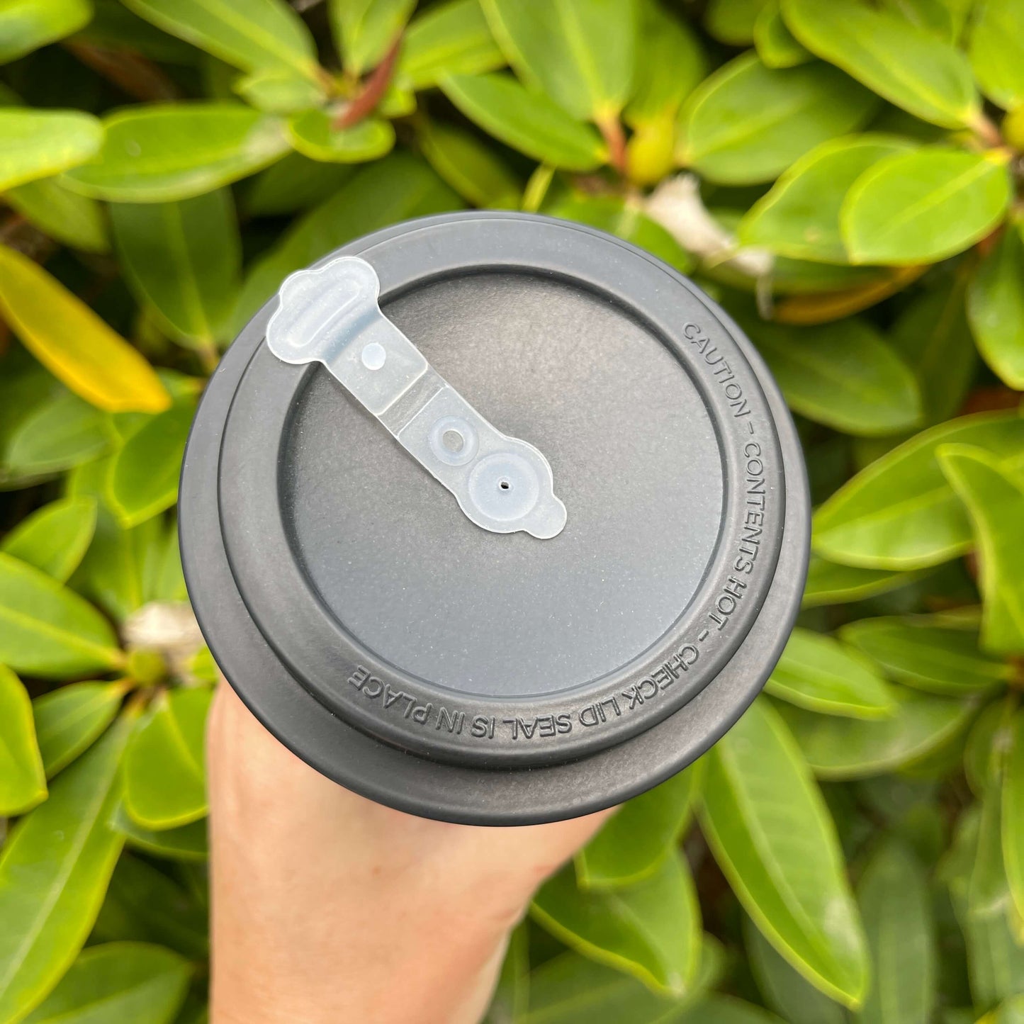 Birds eye view of reusable coffee cup showing the lid and sipper top area.