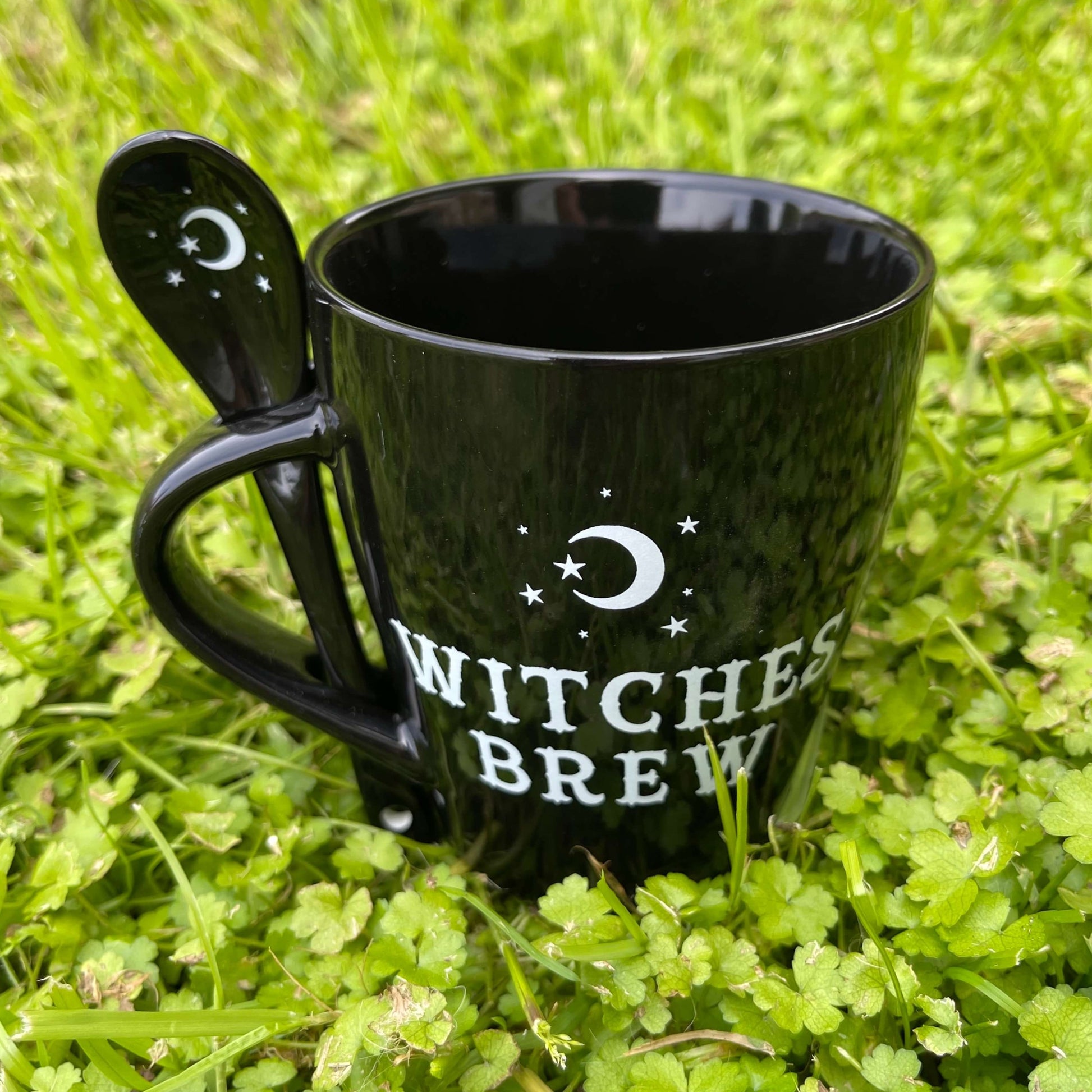 Witches brew mug in black with matching spoon.