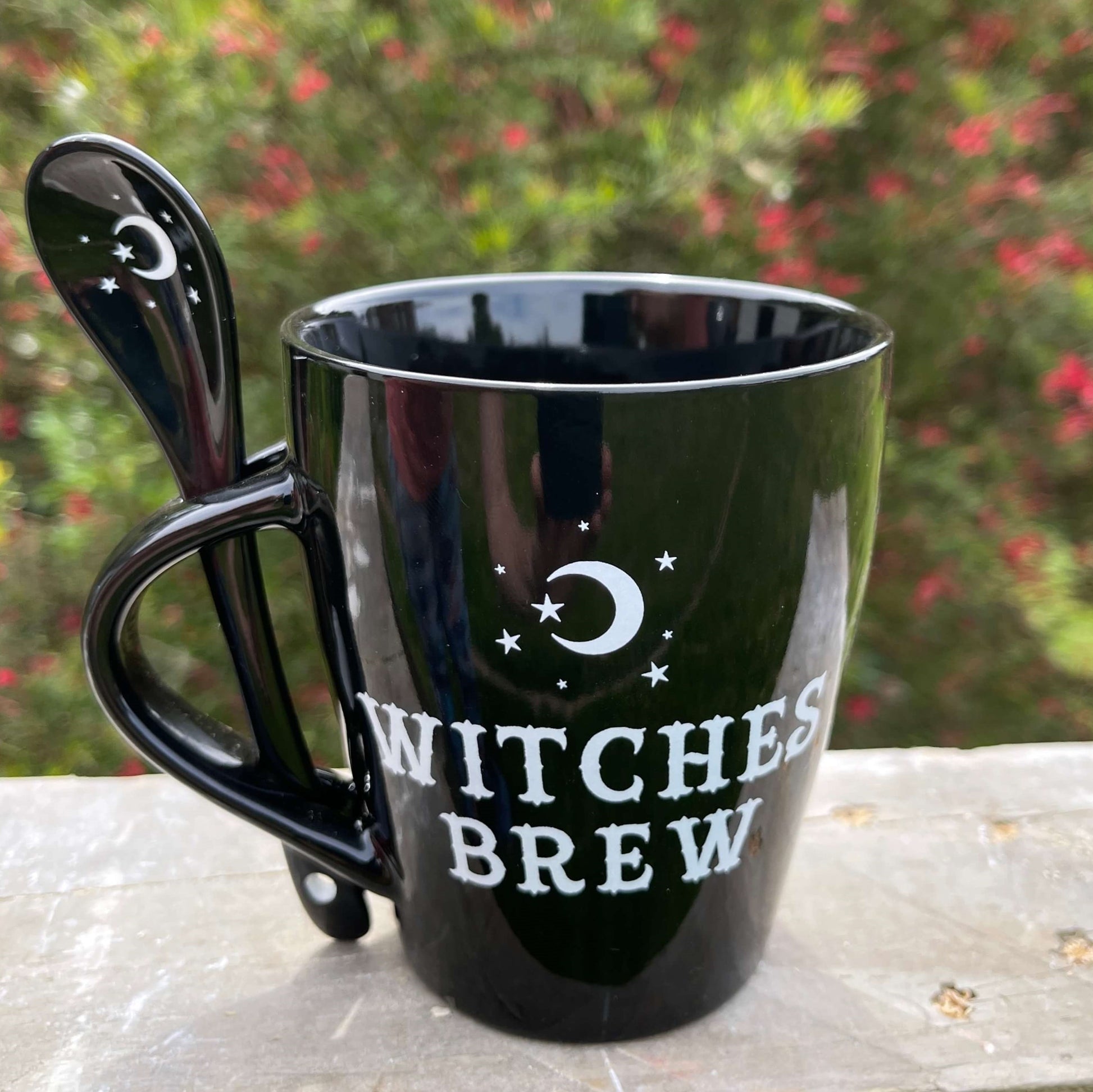 Witches brew mug in black with matching spoon.