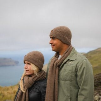 Man & woman wearing brown woolen knit beanie.