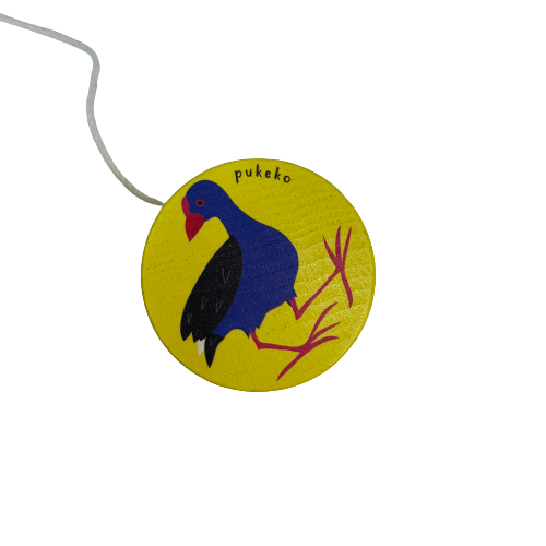 Bright yellow wooden yoyo with a Pukeko painted on it,