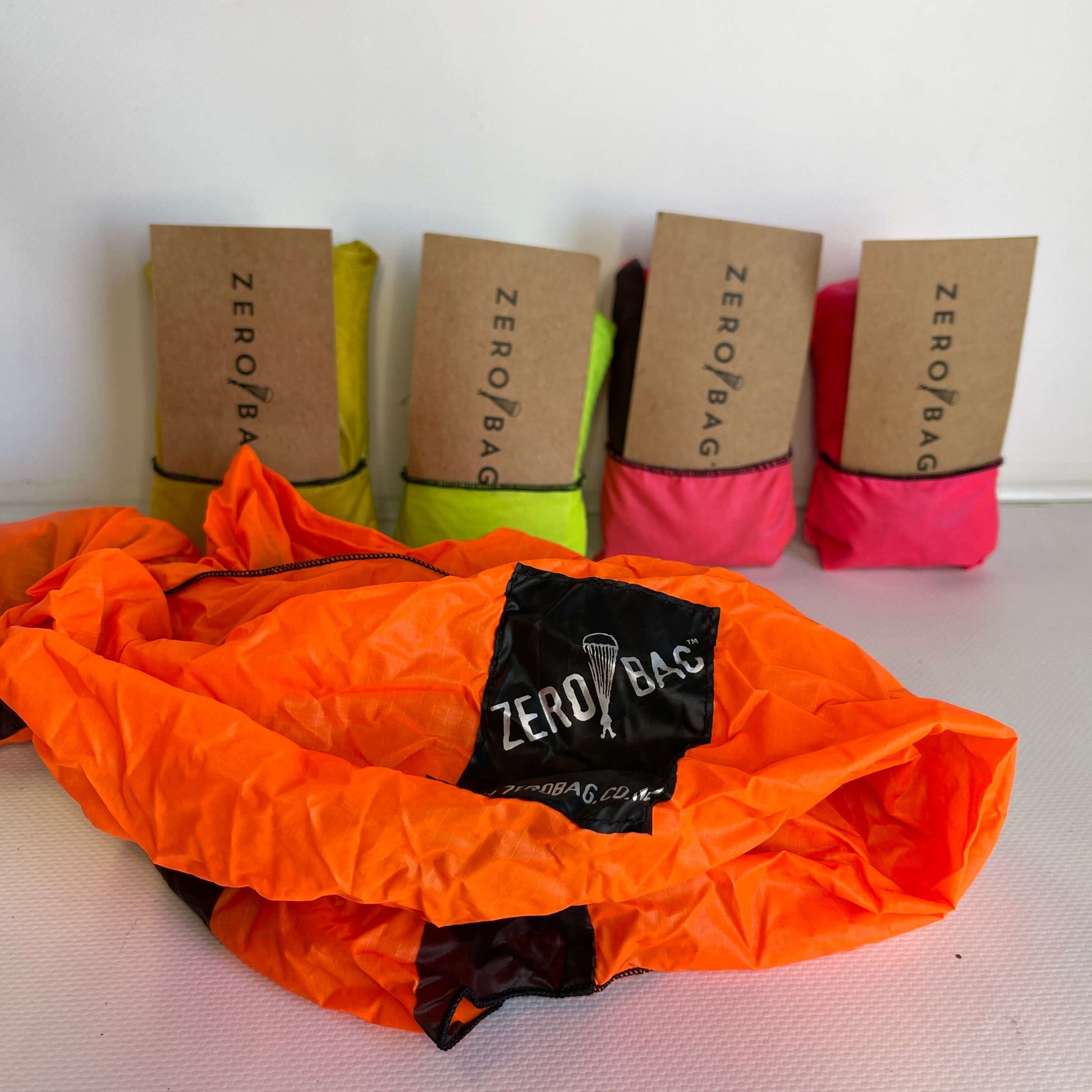 Line up of zero waste tote bags made from parachutes.