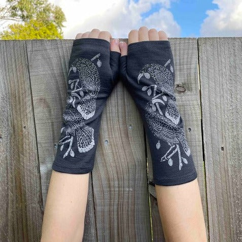 Fingerless merino gloves in charcoal with grey Huia bird print.