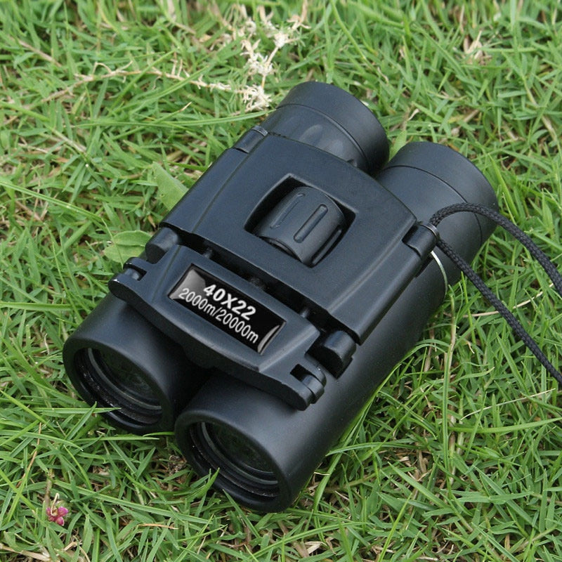 Binoculars sitting in the grass.