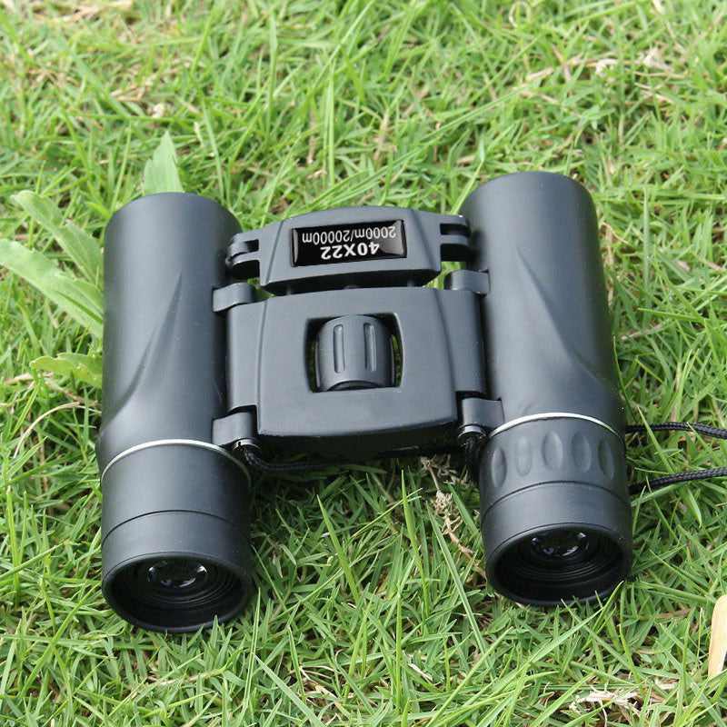 Binoculars sitting in the grass.