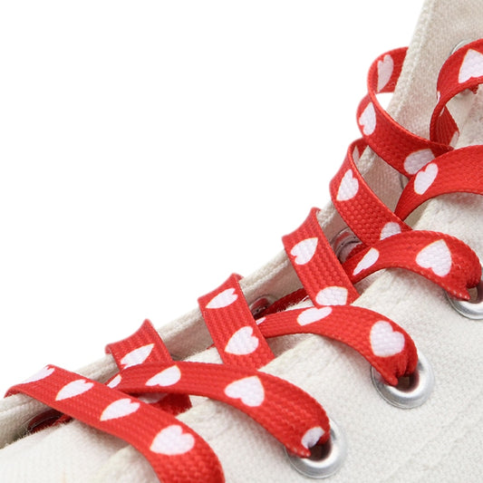 Red shoelaces with white hearts.